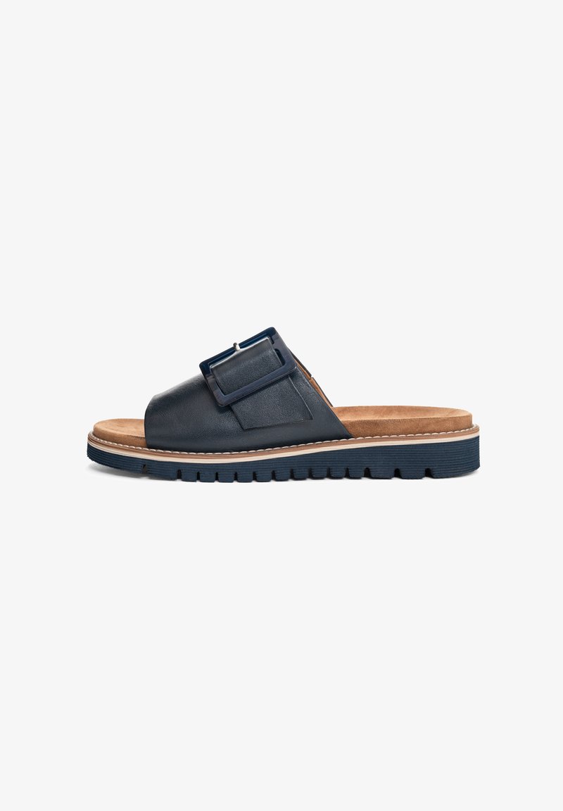 Dark blue leather slide sandal with a wide strap, adjustable buckle detail, and a textured sole; includes a cushioned tan footbed.