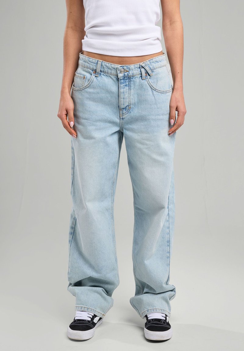 Light blue denim jeans with a relaxed fit, featuring a button closure, five pockets, and visible stitching details.