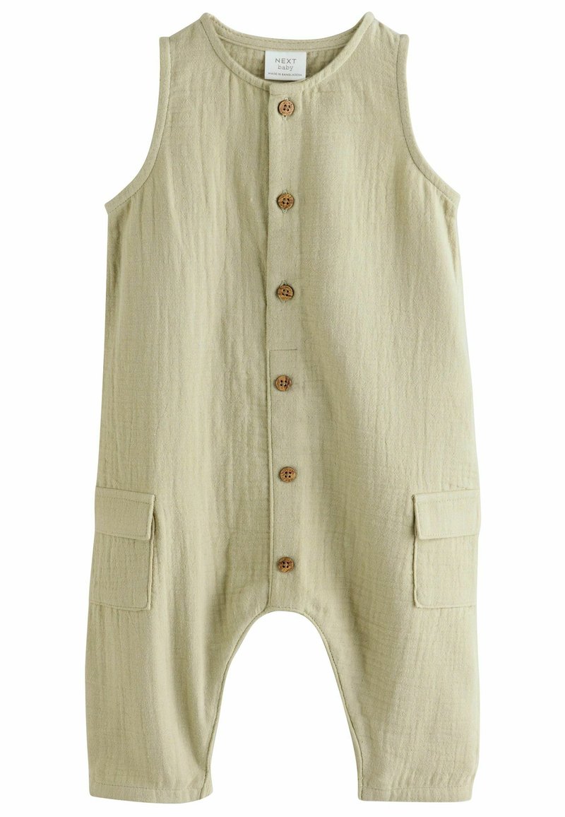 Combinaison en coton vert clair, à coupe ample, sans manches, avec une fermeture à boutons à l'avant et deux poches latérales. Tissu texturé.