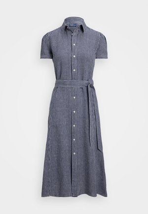 Lühikeste varrukatega nööpidega kleit, mis on tumesinisest ja valgest ruudulisest kangast, vöödiga ning naiseliku talje rõhutamisega, valmistatud kergest kangast.