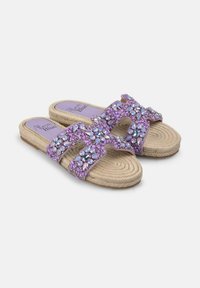 Purple slide sandals with rhinestone embellishments, woven rope detailing on the sole, and a textured fabric upper. Stylish and open-toe design.