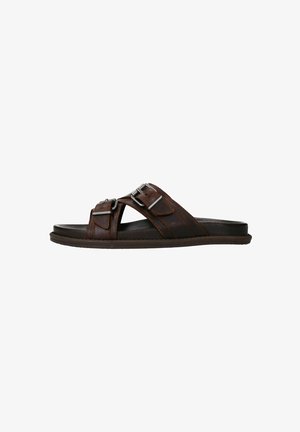 Brown leather slide sandals with two adjustable straps and silver hardware accents. Flat sole with slight texture for grip.