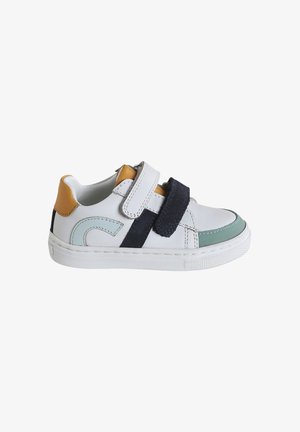 White leather shoe with navy, mint green, and mustard accents. Features two Velcro straps and a textured rubber sole. Stylish design elements.