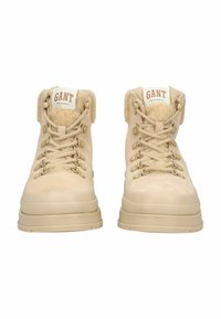 Beige wandelschoenen met een gestructureerde suède bovenkant, gevoerde kraag, metalen oogjes en een dikke rubberen zool. GANT-logo op de tong.