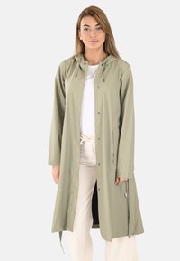 Imperméable vert clair avec capuche, boutons pression sur le devant, poches latérales et design mi-long. Texture lisse et style minimaliste.