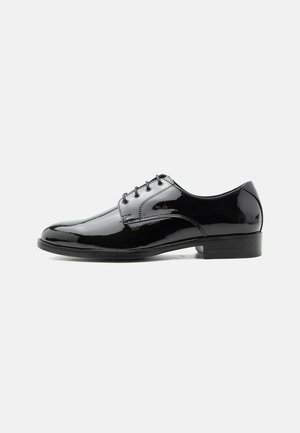 Black polished leather lace-up formal men's shoe with low heel, shown in profile on white background.