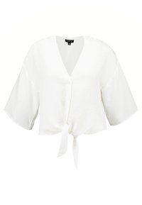 Blouse blanche courte avec un col en V, manches courtes évasées et détail de nouage à l'avant ; tissu lisse avec une texture subtile.