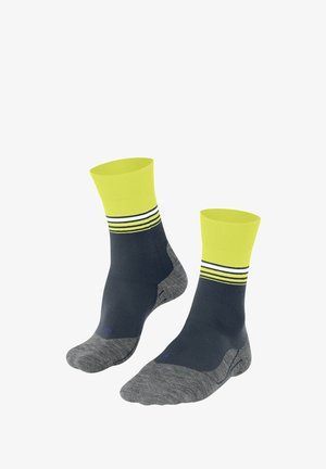 Calzini alla caviglia blu navy e grigi con polsini gialli brillanti e strisce bianche. Presentano una suola imbottita per comfort e supporto.