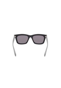 Black square sunglasses with gray temples, featuring dark tinted lenses and metallic accents at the hinges. Matte finish throughout.
