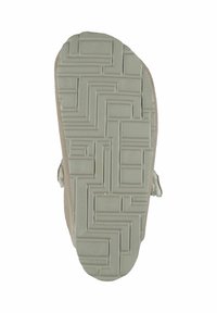 Sole of a shoe, featuring a light beige rubber base with a textured pattern, and soft beige fabric around the edge.