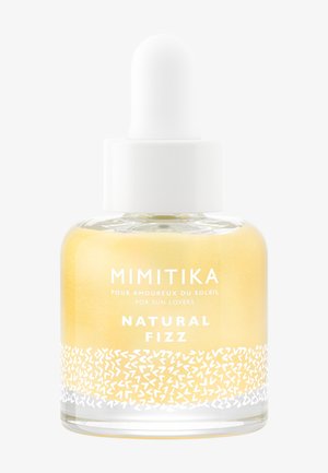 Szklana butelka z kroplomierzem i białą zakrętką, oznaczona Mimitika Natural Fizz, zawierająca żółty płyn z białym dekoracyjnym wzorem.