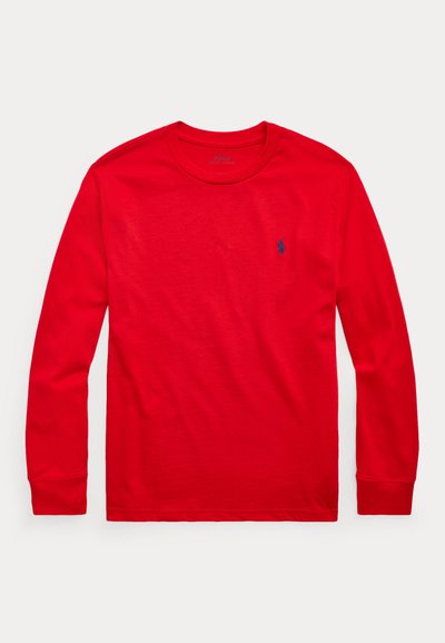 Red long-sleeve crewneck shirt with small blue embroidered logo on left chest, displayed flat on white background.