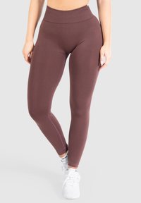 Bordeaux leggins med hög midja, tillverkade av mjuk, stretchig tyg; har platta sömmar och en åtsittande design. Lämpliga för aktiv användning.