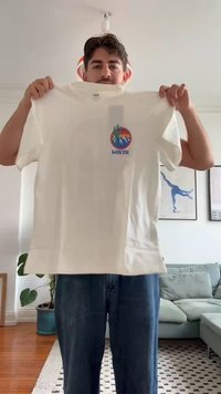 White cotton T-shirt featuring a circular graphic with cacti and mountains in vibrant colors, labeled "Levi's." Short sleeves, crew neck.