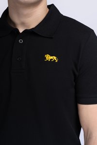 Čierne polo tričko s textúrovanou väzbou, s žltou vyšitou logom leva na ľavej hrudi a s trojkovou gombíkovou légou.