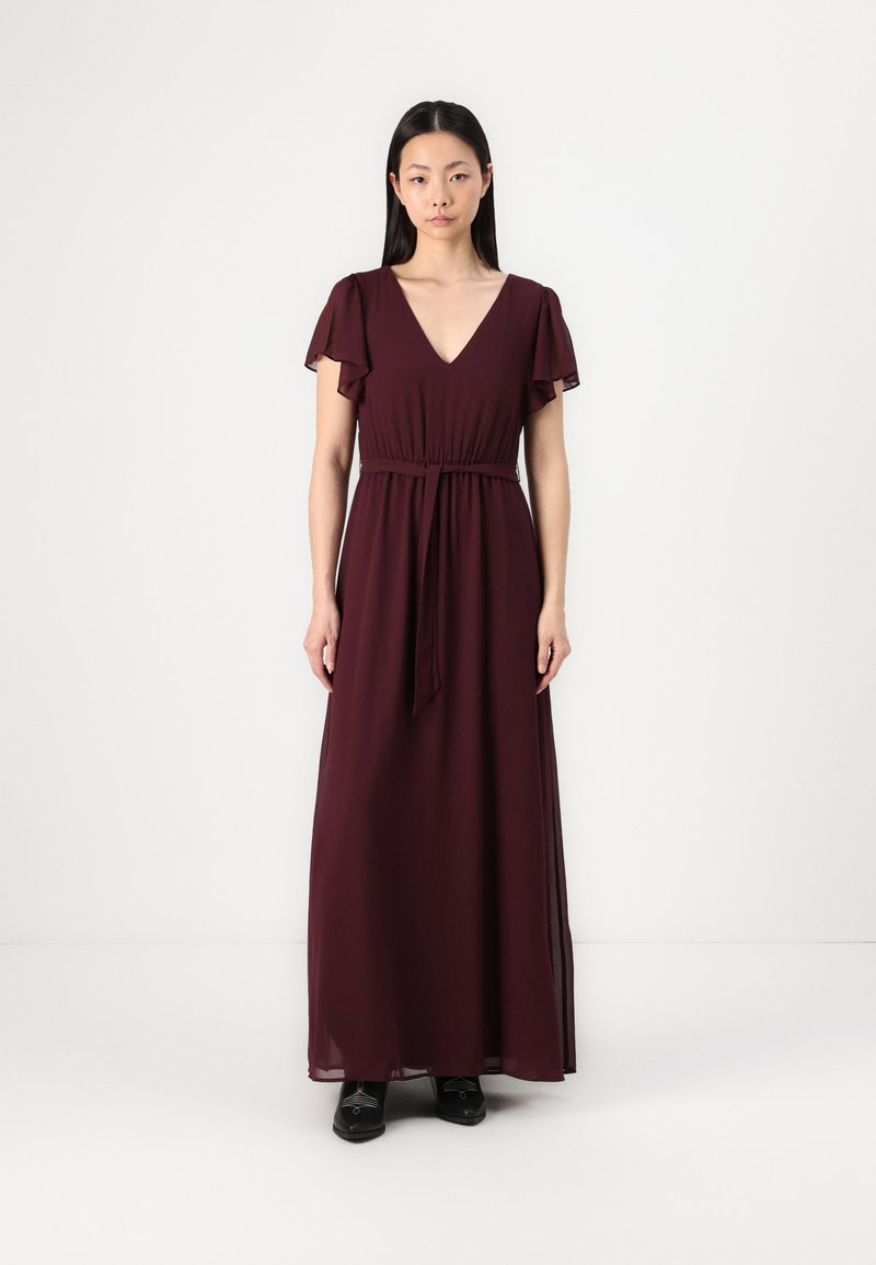 Burgundy maxi dress with short ruffled sleeves, deep V-neck, and an elastic waistband. Smooth, lightweight fabric falls to the ankles.