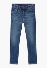 Modré džíny z denimu se slim fit střihem, designem s pěti kapsami a jemným opotřebením v přední části. Obsahují zapínání na knoflík a prošívané detaily.