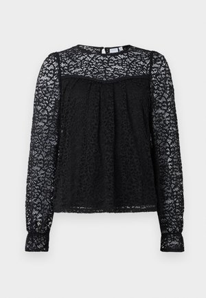Blouse en dentelle noire avec un motif floral texturé. Comprend des manches longues, un col rond et des détails froncés au niveau de la poitrine.