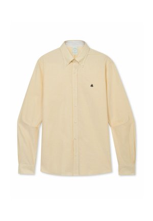 Beige overhemd met lange mouwen en dunne verticale strepen, met knoopsluiting aan de voorkant, puntige kraag en klein zwart logo op de linkerborst.