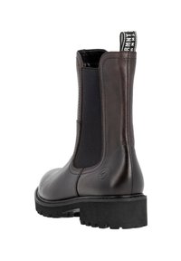 Brown leather ankle boot with elastic side panels and a pull tab, featuring a textured black rubber sole. Smooth finish with subtle stitching details.