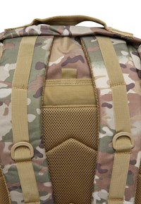 Camo-patterned backpack featuring tan straps, mesh padding, and a sturdy handle. Includes various attachment points and textured sections.