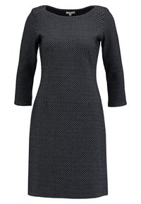 Musta mekko, jossa on teksturoitu geometrinen kuvio, pyöreä pääntie ja kolmen neljänneksen hihat. Valmistettu joustavasta ja mukavasta kankaasta.