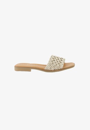 Woven slide sandal in light beige with a flat sole, featuring a textured upper strap and smooth footbed.