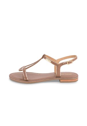 Sandale en cuir marron avec un design à bride en T, semelle plate et fermeture à boucle. Texture lisse et coutures discrètes le long des bords.