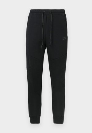 Svarta sweatpants i bomullsblandning, med elastisk midja och dragsko, avsmalnande ben och snedställda sömmar för en modern design.