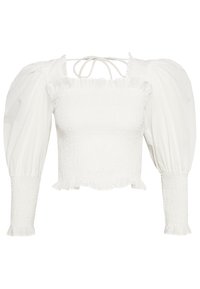 Valkoinen puffihihainen paita, jossa on smokkikuvioinen body, röyhelöreunus ja solmittava kaula-aukko. Valmistettu kevyestä kankaasta, jossa on tekstuuri.