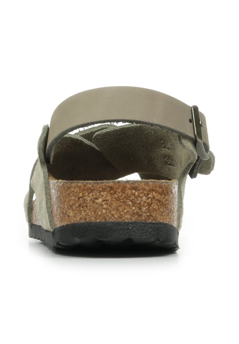 Green suede sandal with a cork footbed, rubber sole, and a flat strap fastening. The back view highlights the textured material and adjustable buckle.
