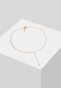 Gold chain necklace with a delicate design, featuring a long drop pendant and a clasp closure for adjustable length.