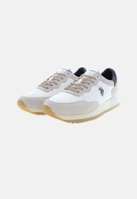 Sneakers featuring a blend of white mesh and light beige suede, black accents at the heel, and a textured gum sole with branding.