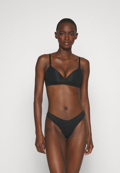 Black bikini set featuring a bra with thin adjustable straps and a V-shaped cup design, paired with a minimalistic thong bottom.