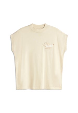 Cream-colored oversized t-shirt with short sleeves, featuring an embroidered bird design on the left chest in neutral tones.