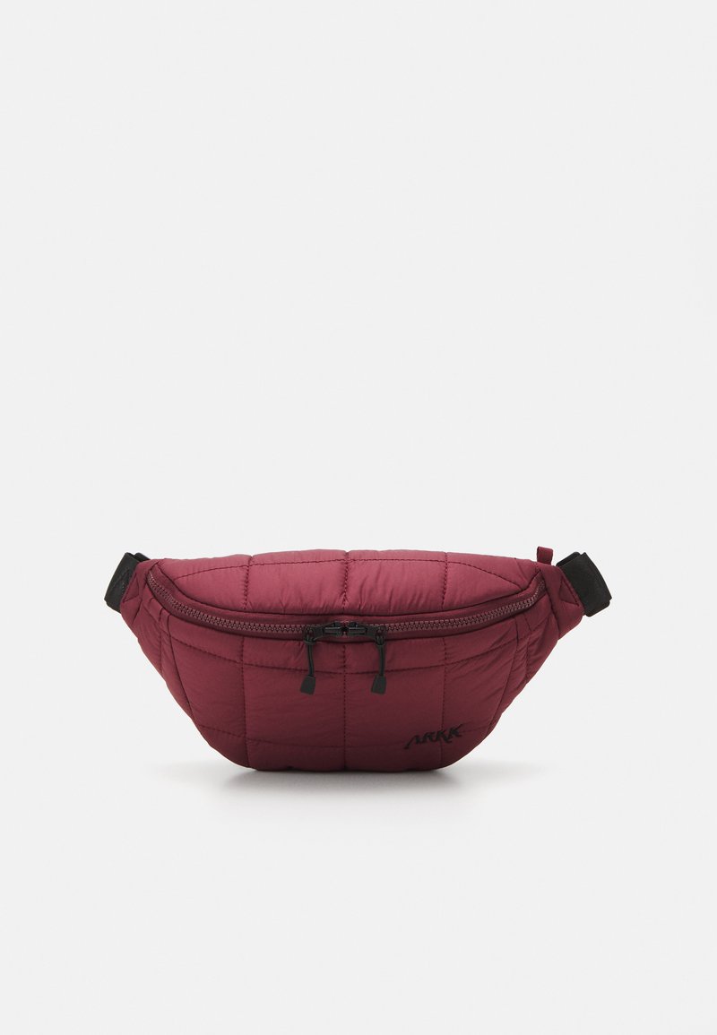 Belt bag in burgundy padded fabric, featuring a black zipper and adjustable strap. Note the quilted texture and printed logo accent.