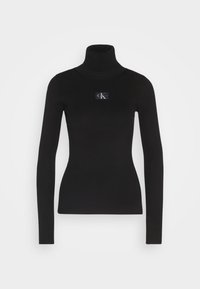Zwarte geribbelde turtleneck trui met lange mouwen en een klein logo-opdruk aan de voorkant. Gemaakt van een rekbare brei-stof.