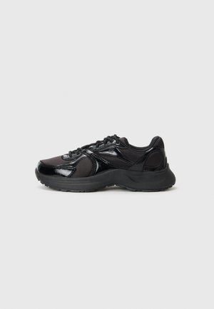 Black athletic sneakers featuring a mix of shiny and matte textures, lace closure, supportive sole, and streamlined design.