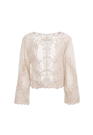 Camicia beige trasparente a maniche lunghe con intricati motivi floreali ricamati e bordi smerlati, esposta su sfondo bianco.