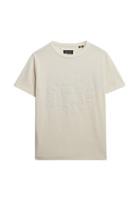 Camiseta de manga corta color beige claro, hecha de algodón suave, con un diseño de texto en relieve de color blanco en disposición circular, y cuello redondo.