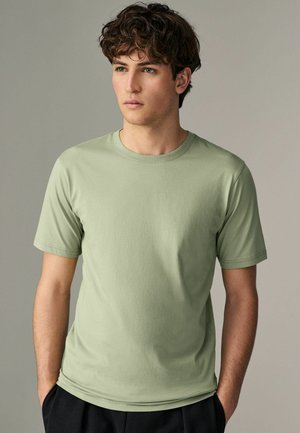 Lichtgroene katoenen T-shirt met korte mouwen en een klassieke ronde hals, met een gladde textuur en een minimalistisch ontwerp.