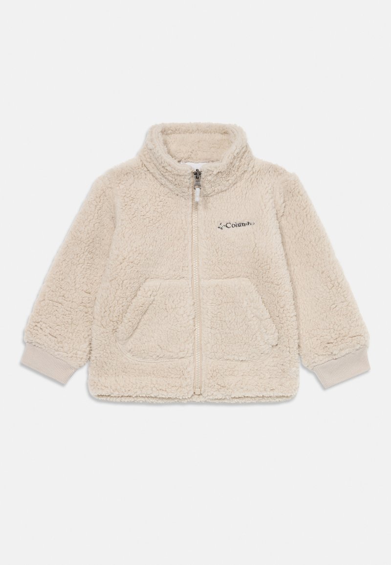 Veste en polaire beige clair avec col haut, fermeture éclair à l'avant, deux poches et poignets côtelés, arborant le logo Columbia en haut à gauche.