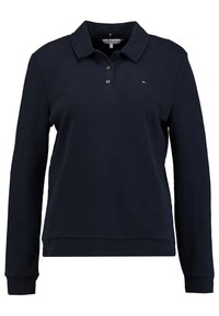 Polo a maniche lunghe blu navy in misto cotone, con colletto, tre bottoni e un piccolo logo sul petto. Texture morbida.