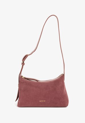 Shoulder bag in soft, dusty rose suede with gold hardware. Curved shape, adjustable strap, and a zip closure. Brand logo featured on front.