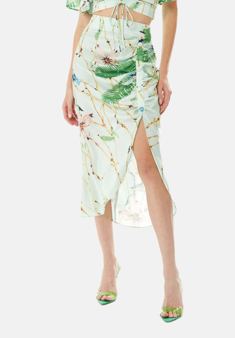 Floral-patterned, light green midi skirt with a side slit, adjustable waist tie, and button details. Smooth fabric with a soft texture.