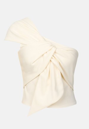 Haut crème à une épaule en tissu lisse, avec un grand détail de nœud torsadé à l'avant et une coupe près du corps.