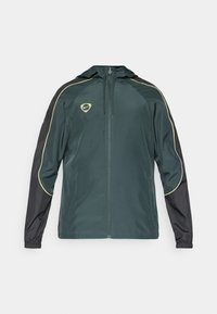 Heren trainingsjack in donker groen en zwart, met een capuchon, ritssluiting en gele accentdetails langs de schouders. Lichtgewicht materiaal.