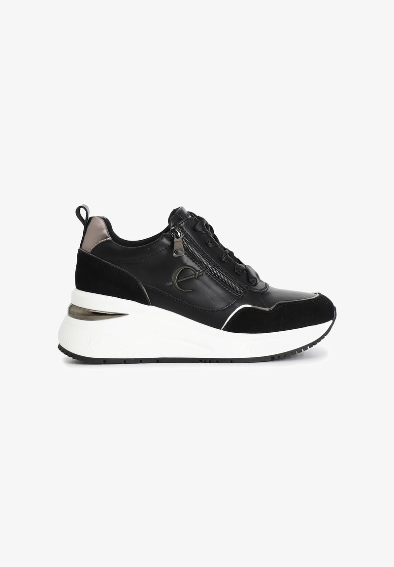 Black sneakers with a mixed material upper featuring suede and leather, a white platform sole, and a decorative zip detail on the side.