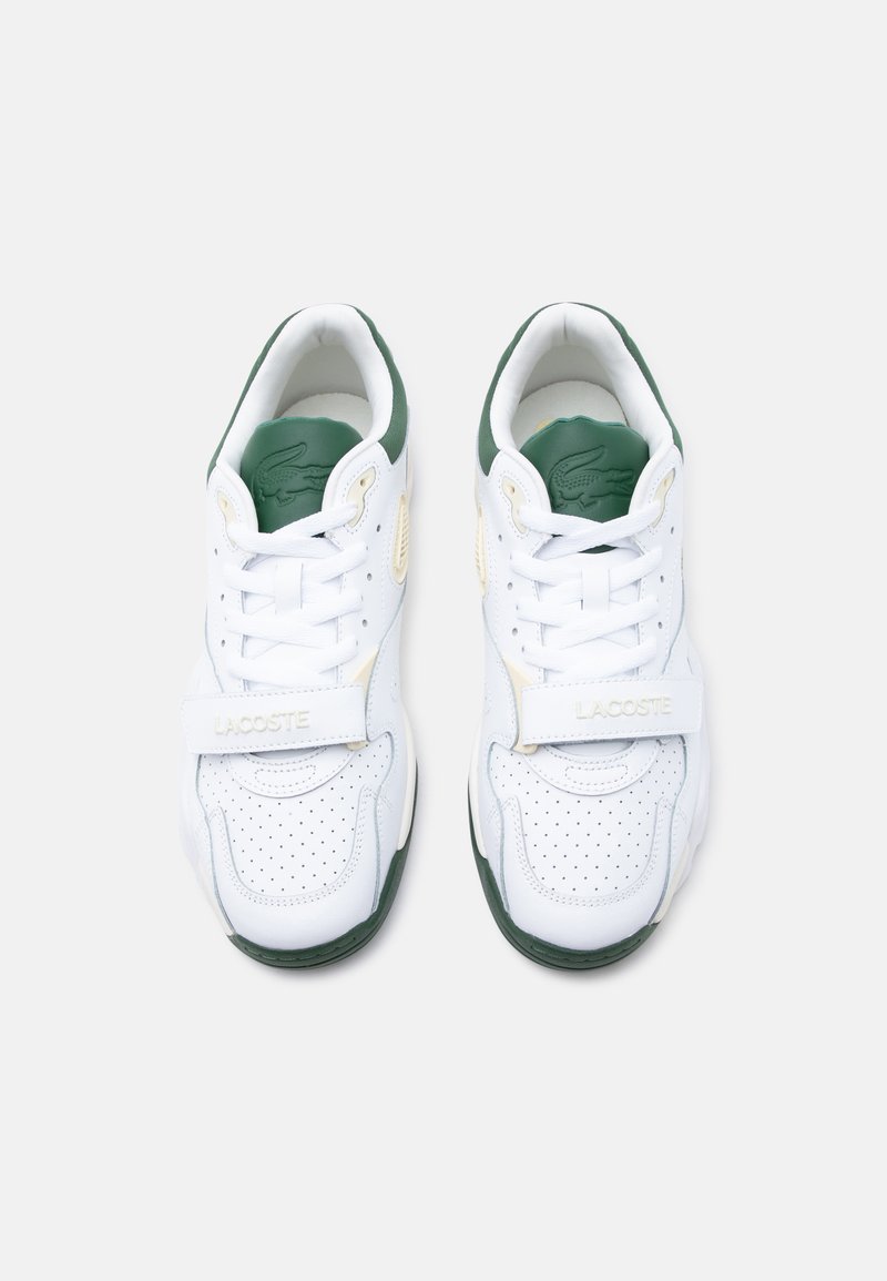 Pair of white and green Lacoste sneakers with perforated toes, lace-up front, and branded velcro straps viewed from above.