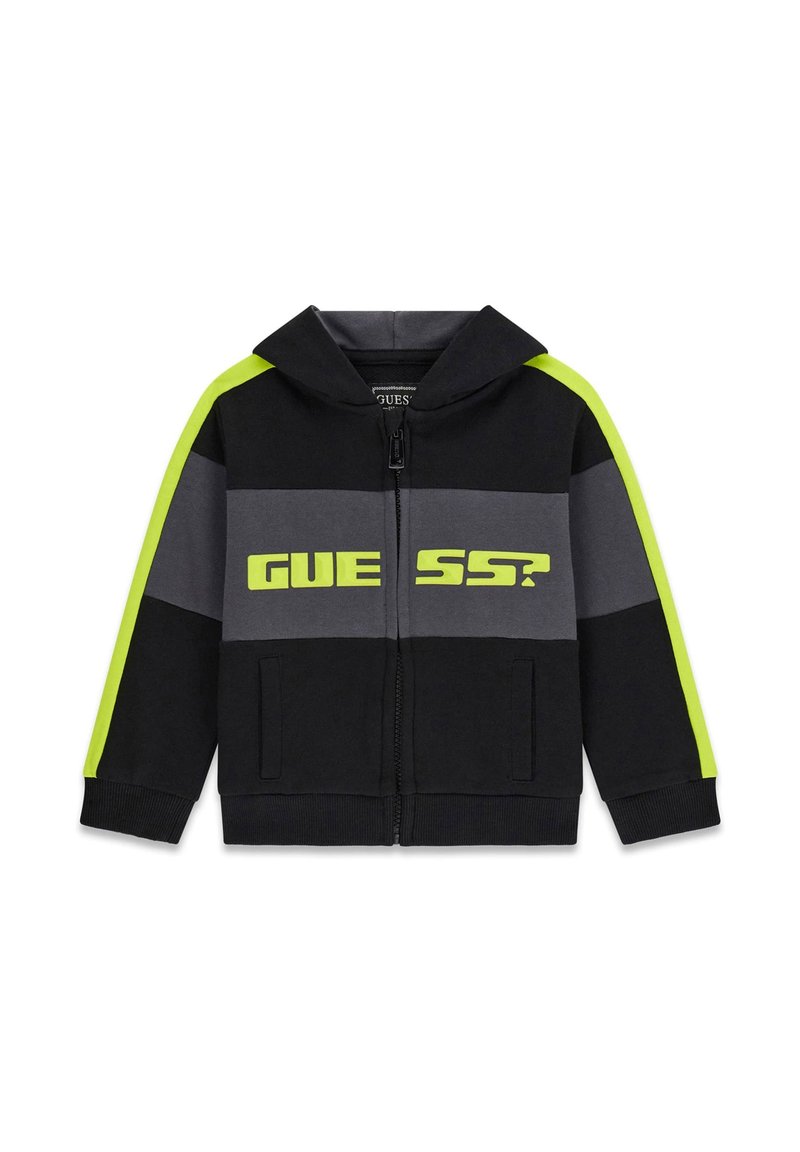 Schwarze und graue Zip-Up Kapuzenjacke mit neon-gelben Streifen an den Ärmeln und dem Text "GUESS?" auf der Brust.